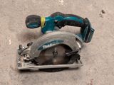 a corded circular saw on the ground next to a corded circular saw