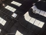a reflection of a skateboarder in the middle of a skate park
