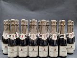 six bottles of wine are lined up in a row on a table