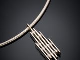 a close up of a necklace on a black surface