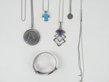 a collection of jewellery including rings, necklaces and a coin