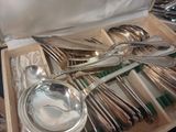 a lot of silverware in a box on the table