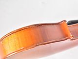 a close up of a violin bow on a white surface