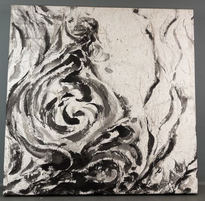 painting of a black and white swirl on a canvas on a table