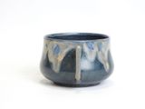 a blue and white bowl on a white surface