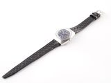 an image of a watch on a white surface with a black strap