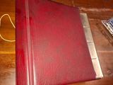 a red book sitting on top of a wooden table
