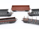 four toy trains that are sitting on a white surface