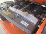 an orange car with a battery in it ' s trunk