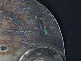 a close up of a metal object with a bird on it