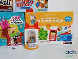 several children ' s books and toys are sitting on a table