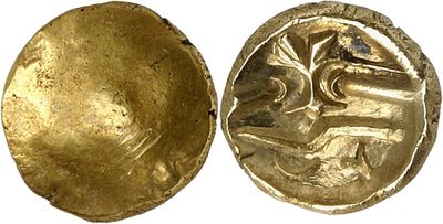 a close up of a gold coin with a woman on it