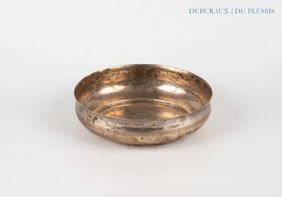 an image of a small brass bowl on a white surface