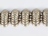 an image of a silver bracelet on a white surface
