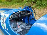 a close up of a blue race car with a steering wheel