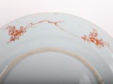 a white plate with orange flowers on it
