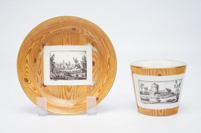 two cups and a plate with a picture on them
