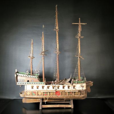 a wooden model of a ship on display on a table