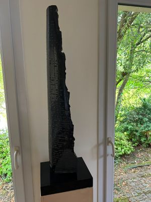 a sculpture on a pedestal in the middle of a room