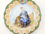 a plate with a picture of a woman and a dog on it