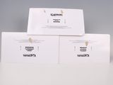 three white business cards stacked on top of each other on a table