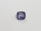 a square blue sapphire stone on a white surface