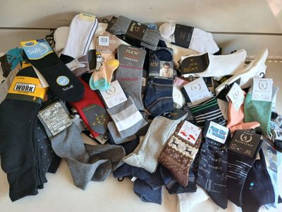 many pairs of socks that are sitting on a table