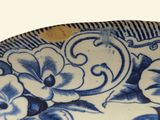 a blue and white plate with flowers on it