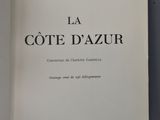 the book is open on a blue surface with a black and white image