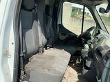 a white van that has a seat in the back of it