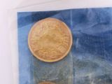 two coins sitting in a plastic bag on a table
