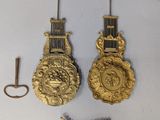 two clocks that are hanging on the wall next to each other