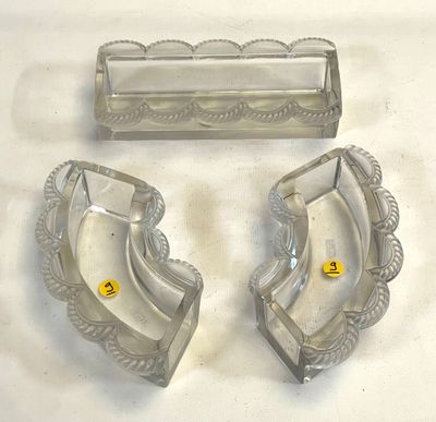 two ashtrays and a cigarette holder on a table