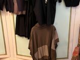 a picture of a closet with clothes hanging on the wall