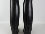 pair of black leather riding boots on a white surface