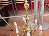 a gold chandelier that is sitting on a table