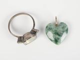 pair of silver and jade heart pendants on a white background