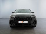 the front view of a grey audi q4 parked in a white room