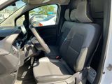 the interior of a white van with two seats and a steering wheel