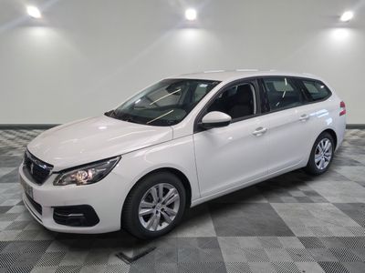 a picture of a white car that is parked in a garage
