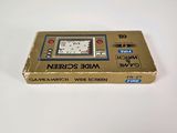 a box with a clock inside of it on a white surface