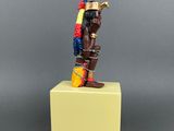 a figurine of a man with a parrot on his head