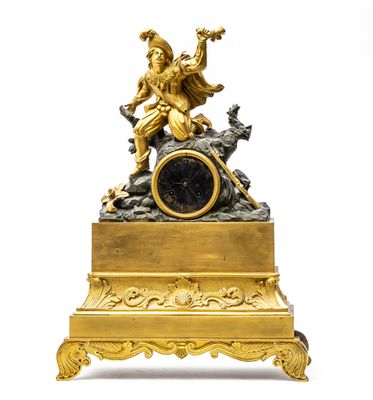 a gold clock with a statue on top of it