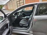 a car with the door open and the driver ' s seat down