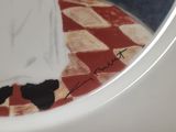 a white plate with a painting of a woman on it