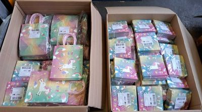 two boxes of soaps that are sitting on the floor