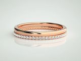 a close up of a rose gold wedding ring with diamonds