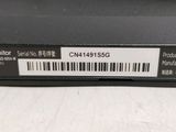 the back of a black laptop with a bar code on it