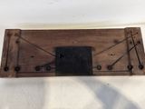 an old wooden board with a metal plate attached to it