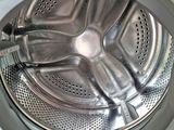 a close up view of a washing machine with the door open